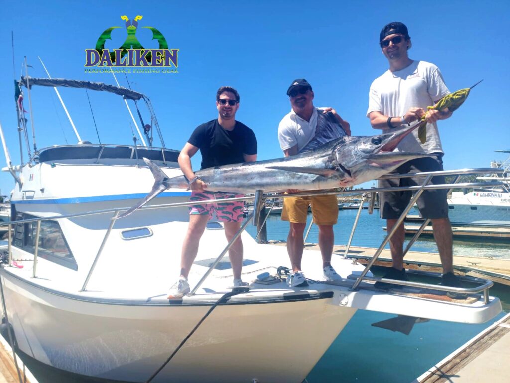 Angler holding dorado and marlin caught in July in San José del Cabo with Daliken Sportfishing