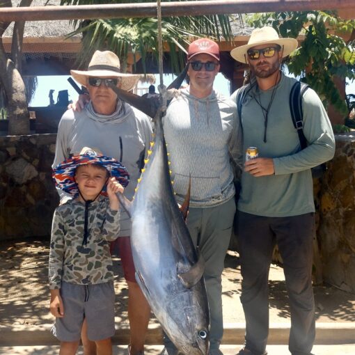 Angler holding 80-pound yellowfin tuna caught on jig near San Luis – Baja fishing action