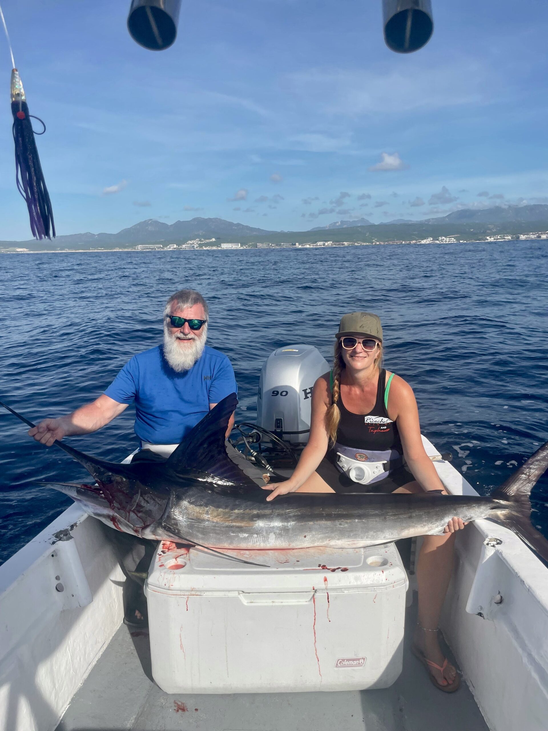 Clients on the 23ft panga with marlin setup