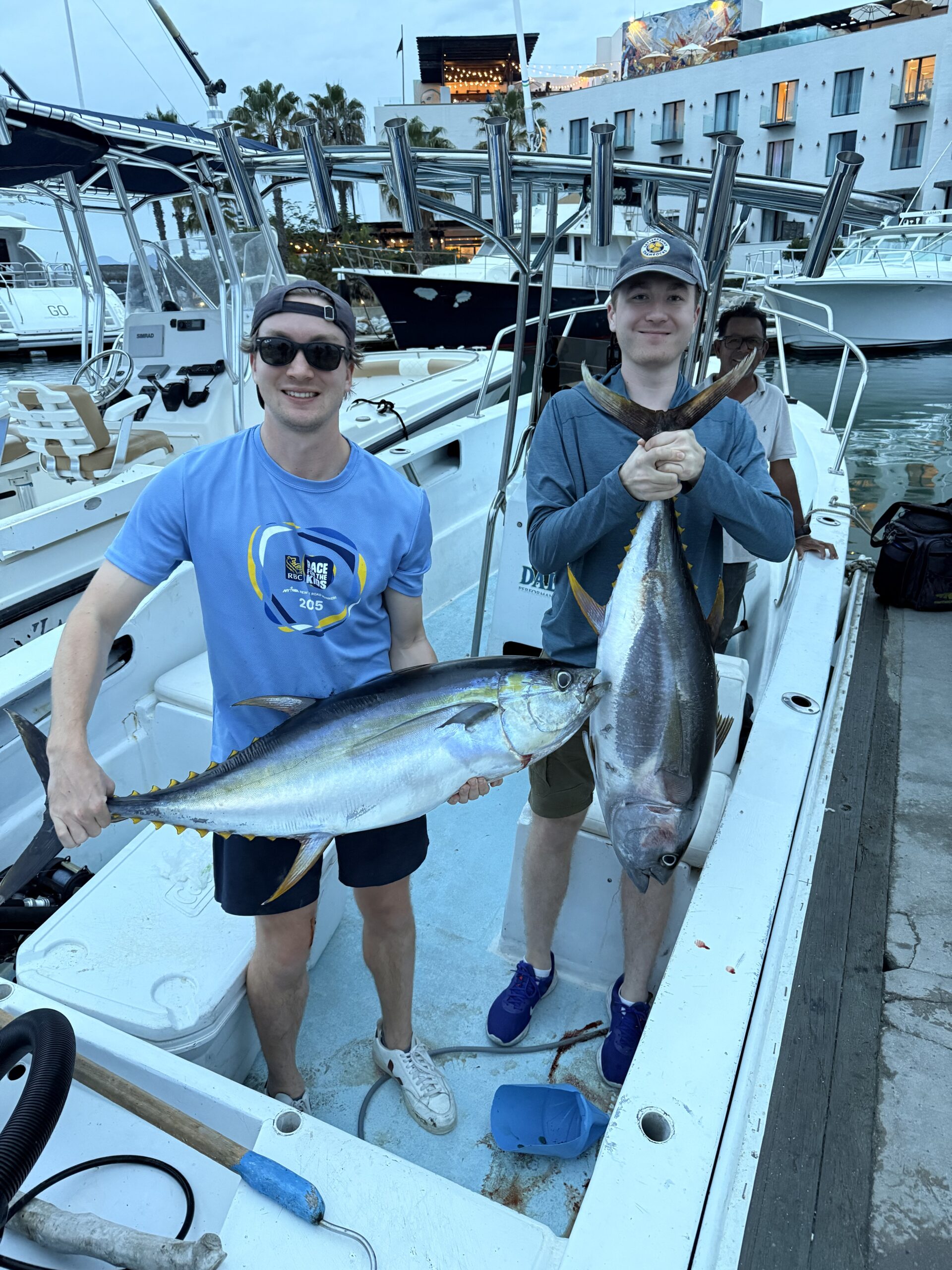 Angler holding a solid yellowfin tuna on the pier after a successful trip from Puerto Los Cabos Marina