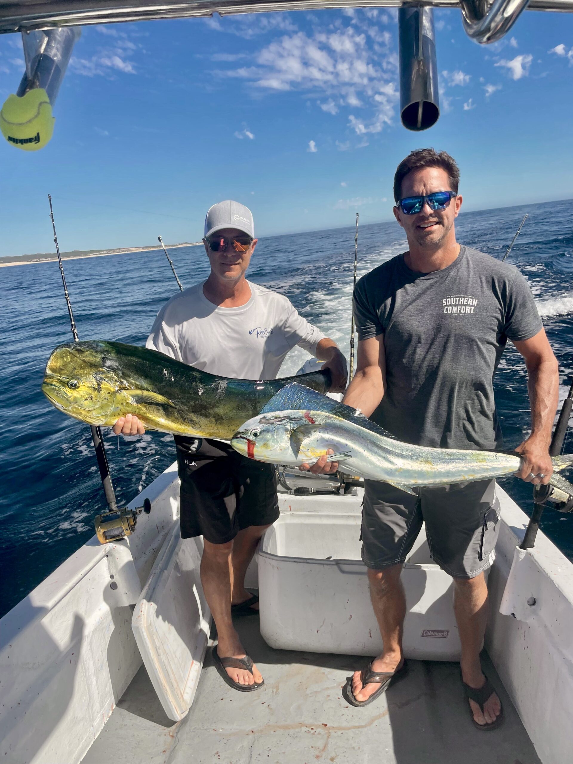 Happy anglers holding fresh mahi mahi dorado near La Fortuna San José del Cabo