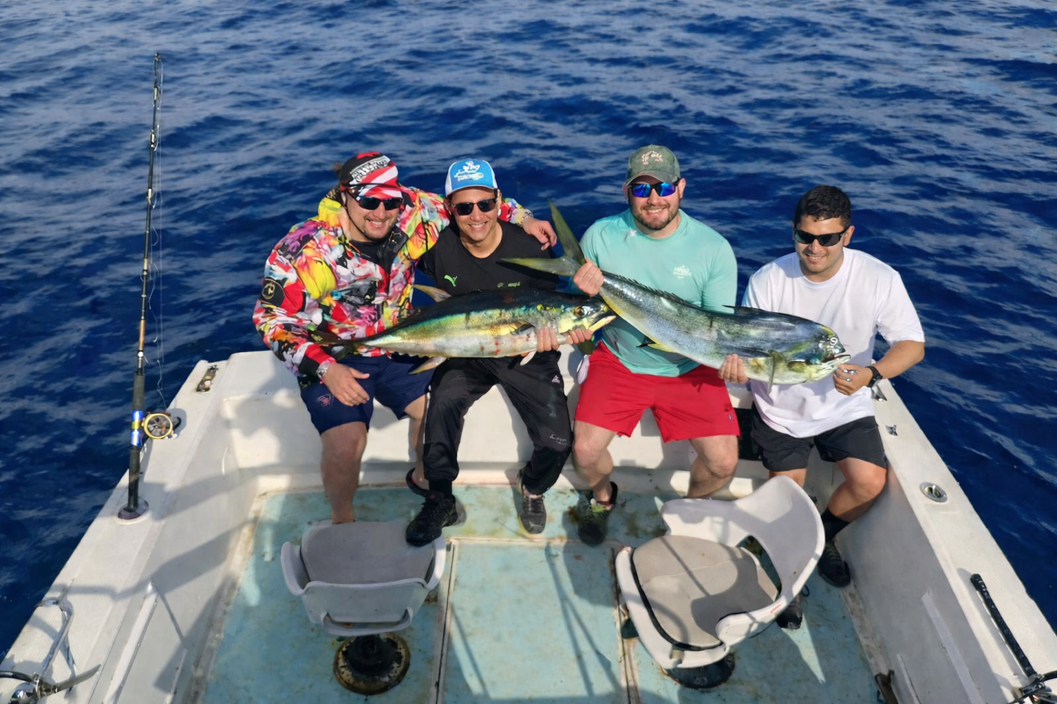 Anglers holding tuna and dorado after offshore fishing near Iman Bank from San José del Cabo
