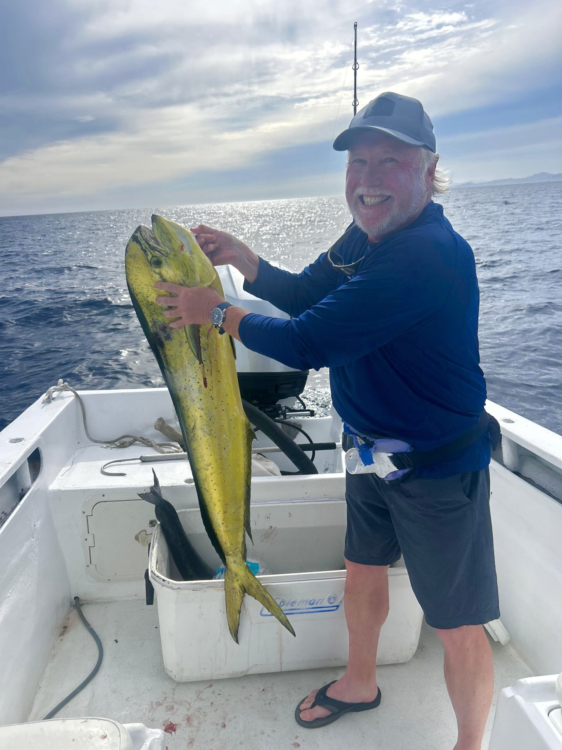 Dorado mahi mahi catch photo with clients on a private fishing trip in Los Cabos