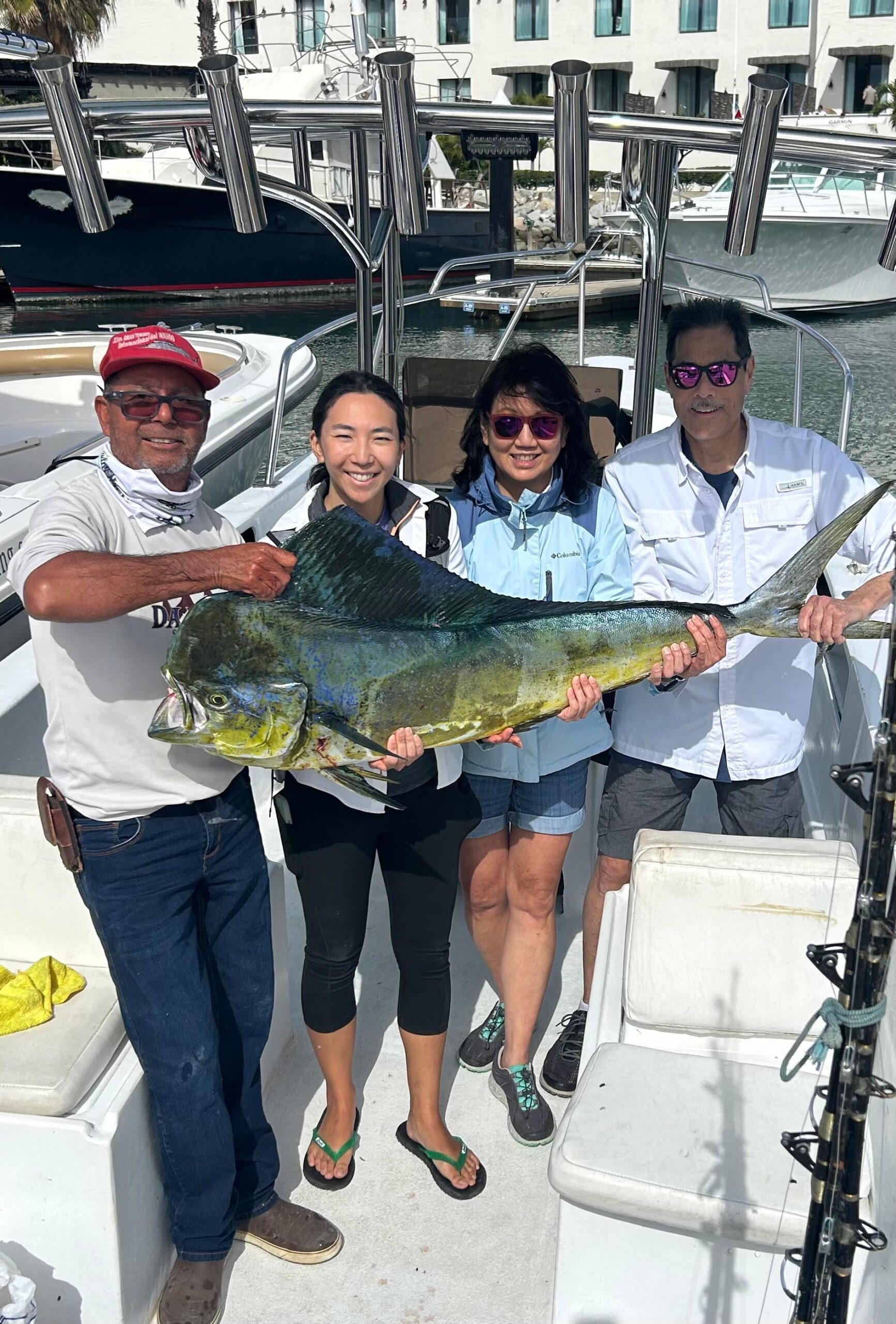 Daliken Sportfishing guests smiling with a mahi mahi catch aboard a panga in Puerto Los Cabos